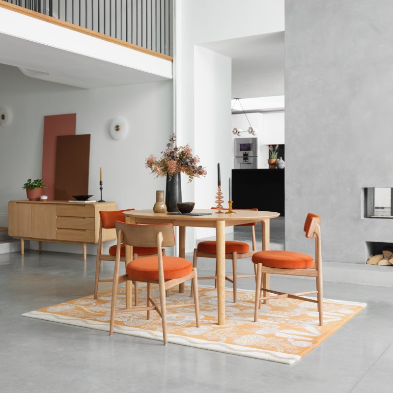 G Plan Winchester Oval Extending Dining Table And 4 Orange Flora Chairs lifestyle image of the dining set