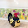 Dora Designs Patchwork Hen Doorstop lifestyle image of the doorstop